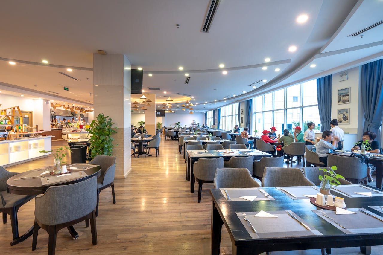Spacious restaurant interior with guests dining and modern decor.